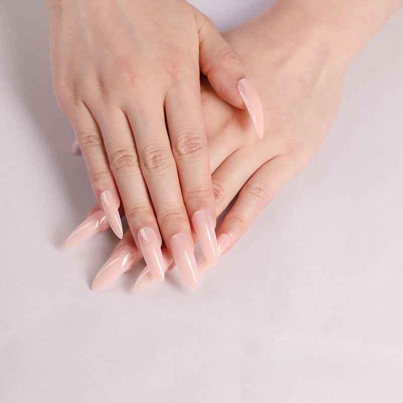 Hands with long, glossy nude pink acrylic nails on a white background